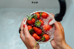 Hemolytic Uremic Syndrome: Image of strawberries being cleaned.